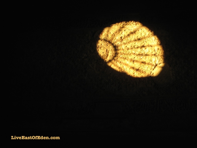 Sun casting light through a window of the Alhambra. Granada, Spain.